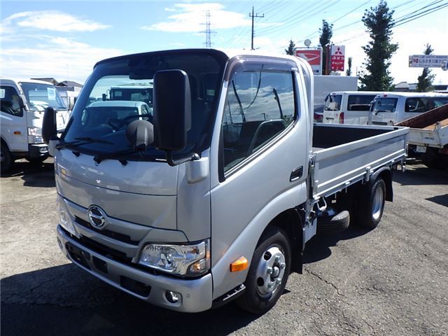 2024 Hino Dutro Base grade 2t flatbed 10ft low-profile dual tires - photo 1 2024 Hino Dutro Base grade 2t flatbed 10ft low-profile dual tires Silver Truck for sale, Japanese used car export - photo 1 of 38 | GULJI TRADERS