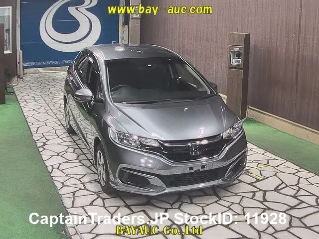 2019 Honda Fit Hibrid - photo 1 2019 Honda Fit Hibrid GRAY Sedan for sale, Japanese used car export | GULJI TRADERS