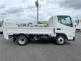2026 Mitsubishi Fuso Canter 2-ton flatbed with vertical gate, collision mitigation braking, 5-speed manual transmission, unused vehicle. White Truck for sale, Japanese used car export - photo 3 of 51 | GULJI TRADERS