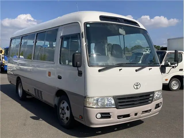 2014 Toyota Coaster LX, 26 seats, automatic doors - photo 1 2014 Toyota Coaster LX, 26 seats, automatic doors White Van for sale, Japanese used car export - photo 1 of 19 | GULJI TRADERS