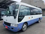 2015 Toyota Coaster Big Bang Long 9-seater with automatic doors White Van for sale, Japanese used car export - photo 1 of 47 | GULJI TRADERS