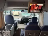 2016 Toyota Coaster 29-seater EX with automatic doors, passenger seat monitors, and refrigerators. Gold Van for sale, Japanese used car export - photo 3 of 30 | GULJI TRADERS