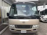 2016 Toyota Coaster 29-seater EX with automatic doors, passenger seat monitors, and refrigerators. Gold Van for sale, Japanese used car export - photo 6 of 30 | GULJI TRADERS
