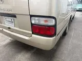 2016 Toyota Coaster 29-seater EX with automatic doors, passenger seat monitors, and refrigerators. Gold Van for sale, Japanese used car export - photo 11 of 30 | GULJI TRADERS