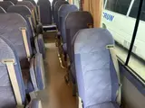 2016 Toyota Coaster 29-seater EX with automatic doors, passenger seat monitors, and refrigerators. Gold Van for sale, Japanese used car export - photo 14 of 30 | GULJI TRADERS