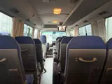 2016 Toyota Coaster 29-seater EX with automatic doors, passenger seat monitors, and refrigerators. Gold Van for sale, Japanese used car export - photo 15 of 30 | GULJI TRADERS