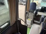 2016 Toyota Coaster 29-seater EX with automatic doors, passenger seat monitors, and refrigerators. Gold Van for sale, Japanese used car export - photo 16 of 30 | GULJI TRADERS