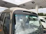 2016 Toyota Coaster 29-seater EX with automatic doors, passenger seat monitors, and refrigerators. Gold Van for sale, Japanese used car export - photo 20 of 30 | GULJI TRADERS