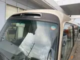 2016 Toyota Coaster 29-seater EX with automatic doors, passenger seat monitors, and refrigerators. Gold Van for sale, Japanese used car export - photo 22 of 30 | GULJI TRADERS