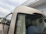 2016 Toyota Coaster 29-seater EX with automatic doors, passenger seat monitors, and refrigerators. Gold Van for sale, Japanese used car export - photo 24 of 30 | GULJI TRADERS