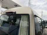 2016 Toyota Coaster 29-seater EX with automatic doors, passenger seat monitors, and refrigerators. Gold Van for sale, Japanese used car export - photo 26 of 30 | GULJI TRADERS