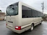 2019 Toyota Coaster EX Rear seat monitor refrigerator Gold Van for sale, Japanese used car export - photo 2 of 8 | GULJI TRADERS