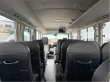2019 Toyota Coaster EX Rear seat monitor refrigerator Gold Van for sale, Japanese used car export - photo 6 of 8 | GULJI TRADERS