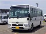 2020 Toyota Coaster Microbus LX Long 29-seater with automatic swing doors, collision mitigation, and automatic transmission. White Van for sale, Japanese used car export - photo 1 of 51 | GULJI TRADERS