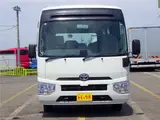 2020 Toyota Coaster Microbus LX Long 29-seater with automatic swing doors, collision mitigation, and automatic transmission. White Van for sale, Japanese used car export - photo 2 of 51 | GULJI TRADERS