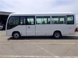 2020 Toyota Coaster Microbus LX Long 29-seater with automatic swing doors, collision mitigation, and automatic transmission. White Van for sale, Japanese used car export - photo 3 of 51 | GULJI TRADERS