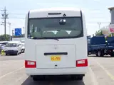 2020 Toyota Coaster Microbus LX Long 29-seater with automatic swing doors, collision mitigation, and automatic transmission. White Van for sale, Japanese used car export - photo 5 of 51 | GULJI TRADERS
