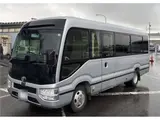 2023 Toyota Coaster GX Silver Van for sale, Japanese used car export - photo 1 of 4 | GULJI TRADERS