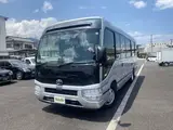 2024 Toyota Coaster GX Long 26-seater Silver Van for sale, Japanese used car export - photo 1 of 24 | GULJI TRADERS