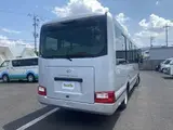 2024 Toyota Coaster GX Long 26-seater Silver Van for sale, Japanese used car export - photo 2 of 24 | GULJI TRADERS