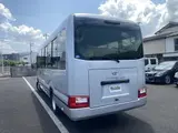 2024 Toyota Coaster GX Long 26-seater Silver Van for sale, Japanese used car export - photo 9 of 24 | GULJI TRADERS