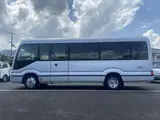 2024 Toyota Coaster GX Long 26-seater Silver Van for sale, Japanese used car export - photo 11 of 24 | GULJI TRADERS