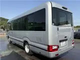 2025 Toyota Coaster Long GX Silver Van for sale, Japanese used car export - photo 2 of 44 | GULJI TRADERS