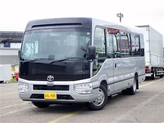 2026 Toyota Coaster Microbus GX, 28-seater, unused, current model, refrigerator, monitor. Silver Van for sale, Japanese used car export | GULJI TRADERS