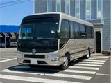 2026 Toyota Coaster EX Brown Van for sale, Japanese used car export - photo 1 of 74 | GULJI TRADERS