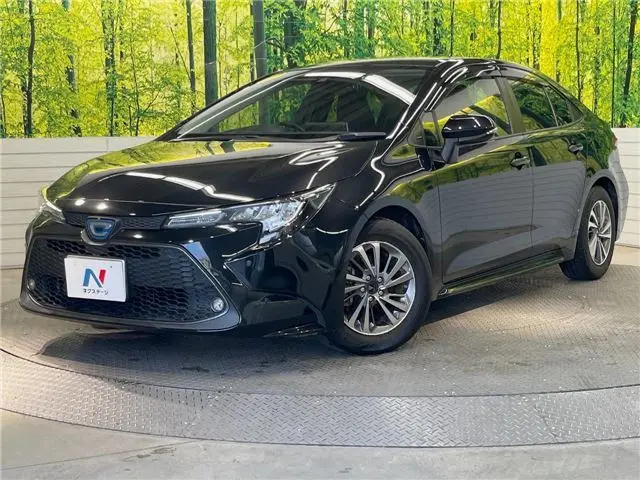2021 Toyota Corolla Hybrid G-X Plus - photo 1 2021 Toyota Corolla Hybrid G-X Plus Black Sedan for sale, Japanese used car export - photo 1 of 30 | GULJI TRADERS