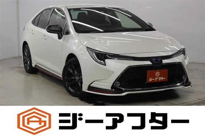 2021 Toyota Corolla 1.8 HYBRID WxB 4WD White Sedan for sale, Japanese used car export - photo 1 of 29 | GULJI TRADERS