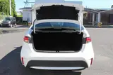 2024 Toyota Corolla 1.8 HYBRID G White Sedan for sale, Japanese used car export - photo 26 of 30 | GULJI TRADERS