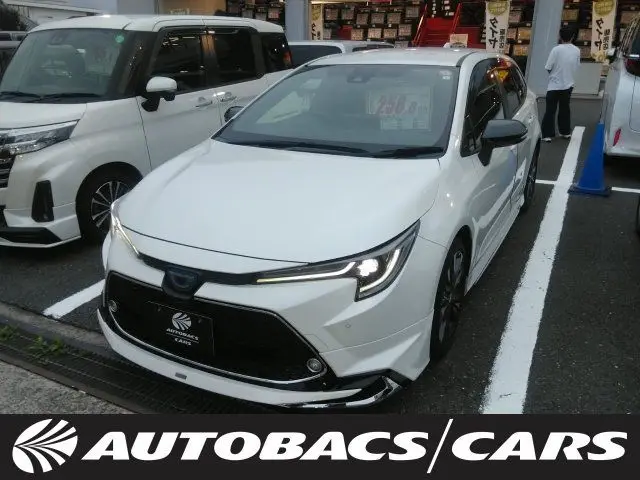 2021 Toyota Corolla Touring HYBRIDW×B 2WD - photo 1 2021 Toyota Corolla Touring HYBRIDW×B 2WD Pearl Van for sale, Japanese used car export - photo 1 of 24 | GULJI TRADERS