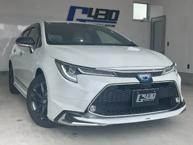 2021 Toyota Corolla Touring 4WD HYBRID WXB - photo 1 2021 Toyota Corolla Touring 4WD HYBRID WXB White Van for sale, Japanese used car export - photo 1 of 24 | GULJI TRADERS