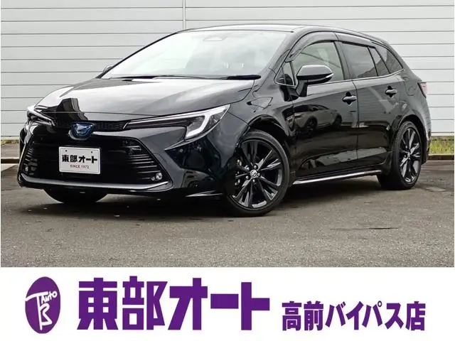 2024 Toyota Corolla Touring 1.8 Hybrid WxB E-Four 4WD - photo 1 2024 Toyota Corolla Touring 1.8 Hybrid WxB E-Four 4WD Black Van for sale, Japanese used car export - photo 1 of 37 | GULJI TRADERS