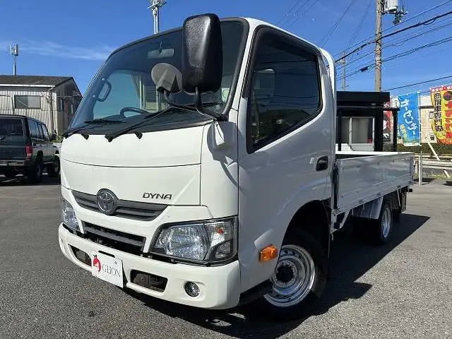 2019 Toyota Dyna Truck 1.5t capacity, flatbed truck, standard driver's license required, steel bed floor, 5-speed manual transmission. White Truck for sale, Japanese used car export - photo 1 of 45 | GULJI TRADERS