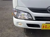 2021 Toyota Dyna Truck Flatbed, standard, low-floor, suitable for regular driver's licenses, with wooden floorboards, navigation system, TV, keyless entry, 1.5t capacity. White Truck for sale, Japanese used car export - photo 2 of 51 | GULJI TRADERS
