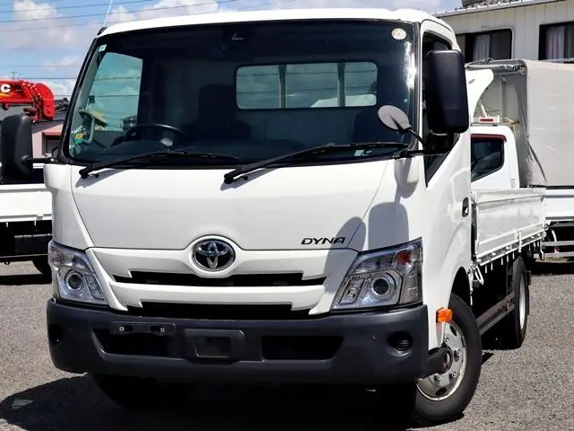 2021 Toyota Dyna Truck Flatbed, 2-ton load capacity, wide and long, low-floor design. White Truck for sale, Japanese used car export - photo 1 of 6 | GULJI TRADERS
