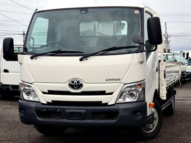2021 Toyota Dyna Truck Flatbed, 3-ton load capacity, wide long, low-floor design. White Truck for sale, Japanese used car export - photo 1 of 6 | GULJI TRADERS