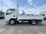 2025 Toyota Dyna Truck 1.4-ton 10-foot flatbed 4WD truck with reduced braking system and 5-speed manual transmission. White Truck for sale, Japanese used car export - photo 3 of 42 | GULJI TRADERS